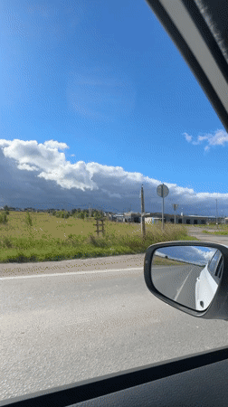 Driving past greenhouses and buildings on a Russian road