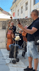 Street musicians perform near Roman landmarks in Pula, Croatia