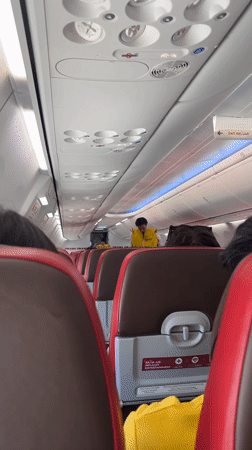 Passenger documents flight safety demo, wing views near Kuta