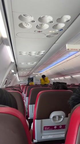 Passenger documents flight safety demo, wing views near Kuta