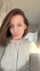 Woman records selfie videos in kitchen, Reshetnikovo Russia