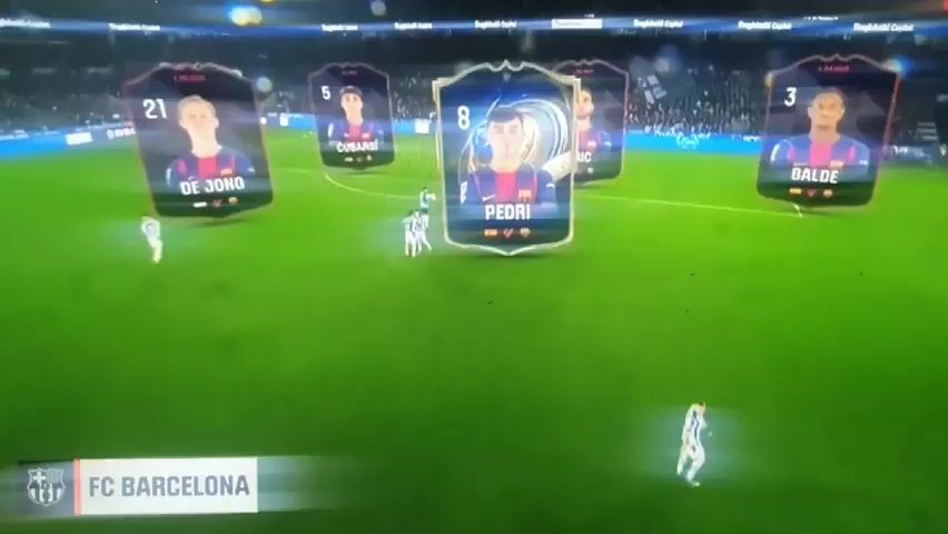 The video shows a soccer field with players visible in the distance. In the foreground are floating cards with player names and photos. The cards display the names Lamine, Olmo, Cubarsi, Pedri, and Balde. The team name FC Barcelona is at the bottom of the screen. An orange rectangle obstructs the view of another player card. Players wearing white uniforms are visible on the field. The overall environment suggests a broadcast or video game representation of a soccer match.