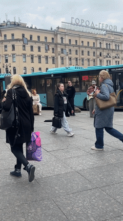 Street musicians perform in Saint Petersburg square amid pigeons