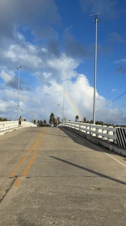 Rainbow appears over General Luna, Philippines bridge scene