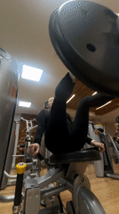 Woman exercises on leg press machine at Krasnoyarsk gym