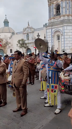 Religious procession with brass bands and floral floats in Lima
