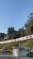 Train passes castle tower in Sochi amid clear skies