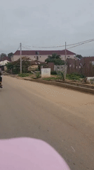 Motorcycle riders navigate morning streets in Keffi, Nigeria