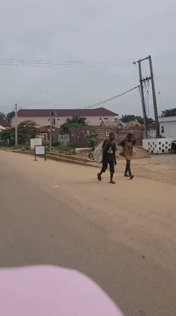 Motorcycle riders navigate morning streets in Keffi, Nigeria