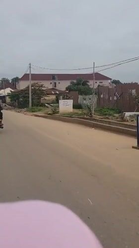 Motorcycle riders navigate morning streets in Keffi, Nigeria