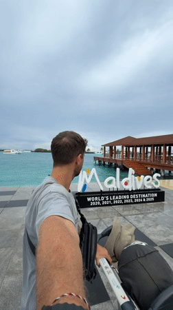 Man pushes stroller during early morning walk in Malé