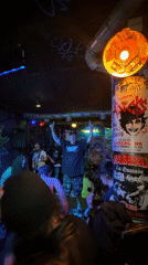 Three people gather in Barcelona bar with musical equipment