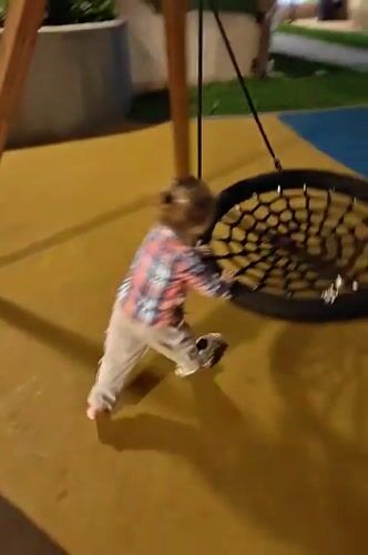 Child plays on Mumbai playground with balance bike