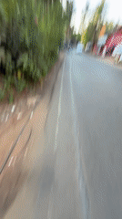 Person walks paved road in Calangute wearing casual attire