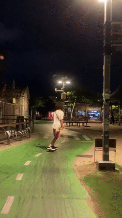 Night rollerblading on a green urban path in Tel Aviv