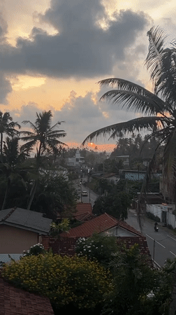 Sunset over Goviyapana's palm-lined coast and village rooftops