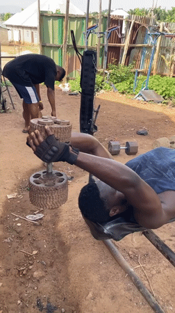 Men use makeshift outdoor gym equipment in Akwanga, Nigeria