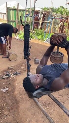 Men use makeshift outdoor gym equipment in Akwanga, Nigeria