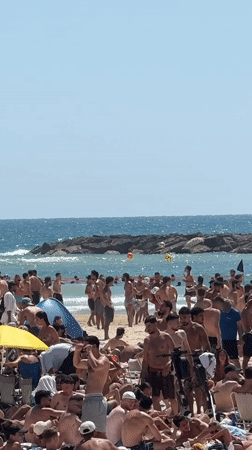 Tel Aviv residents enjoy sunny beach day amid urban activity