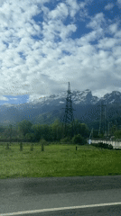 Vehicle passes electrical station in mountainous Редант region