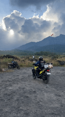 Two motorcyclists pause in volcanic landscape near Kintamani
