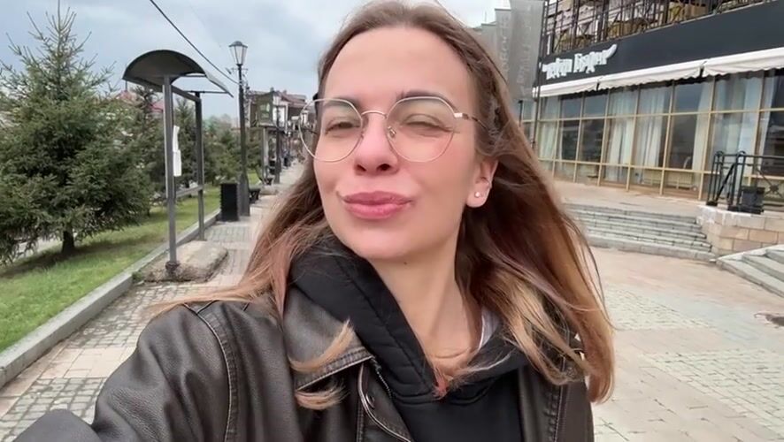 Woman films herself on pedestrian street in Irkutsk