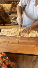 Bakery workers prepare flatbread in Sochi food establishment