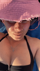 Beach day with sunbathing and selfies on pebbled shore