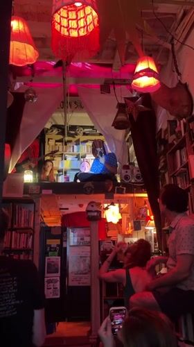 Intimate live music set in a dimly lit New York bookstore venue