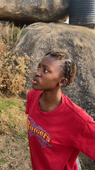 Woman in red shirt observed in rocky area, Vom Nigeria