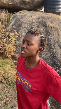 Woman in red shirt observed in rocky area, Vom Nigeria
