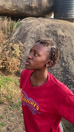 Woman in red shirt observed in rocky area, Vom Nigeria