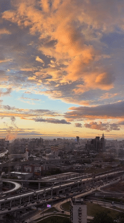 Sunset cityscape documented in Khimki, Russia featuring illuminated skyscraper