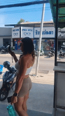 Woman with camera spotted on sunny Thailand street