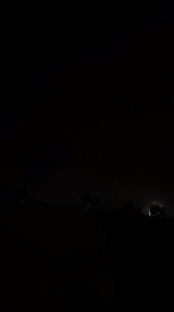 Lightning storm rolls in over a coastal Greek village at night