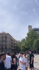 Barcelona intersection bustling with pedestrians and cyclist on sunny day