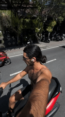 Man rides scooter through North Kuta streets early morning