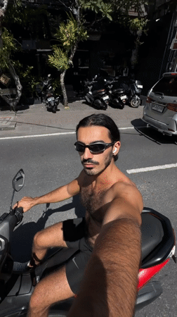 Man rides scooter through North Kuta streets early morning