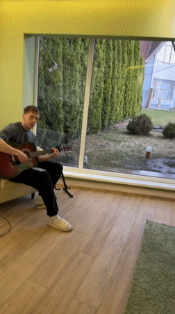 Musician performs with tulips present in Kursk home