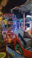 Kids on carnival rides at Taman Kota Sumbersari after dark