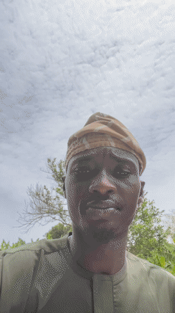 Man takes selfies in traditional dress in Badagry