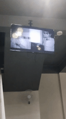 Cafe patron documents televised music videos in Indonesian establishment