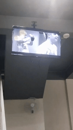 Cafe patron documents televised music videos in Indonesian establishment