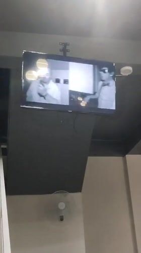 Cafe patron documents televised music videos in Indonesian establishment