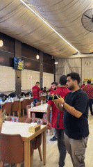 Camera crew and staff gather inside a Gaza restaurant