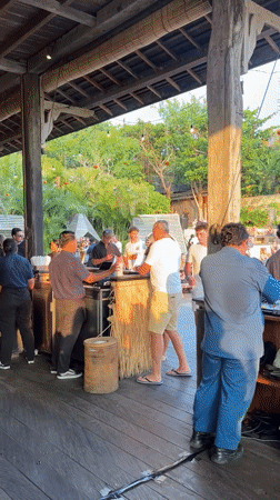 Daytime poolside party with DJ and bar crowd in Kuta Selatan