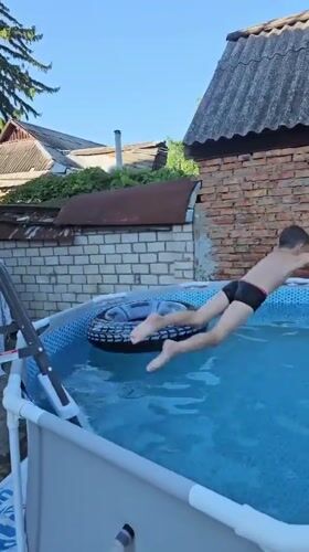 Pool jump with inflatable tube on a summer afternoon