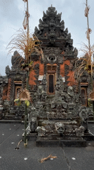 Tourist documents traditional Balinese temples and crafts in Ubud