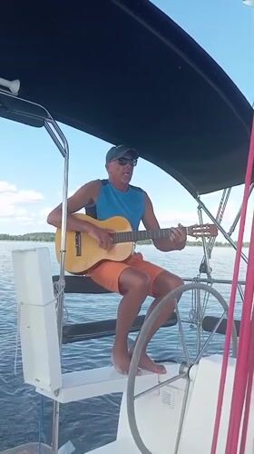 Guitar on a sailboat, seagull on a buoy, calm Polish lake