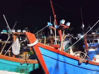 Traditional fishing boats docked at Lhokseumawe harbor at night